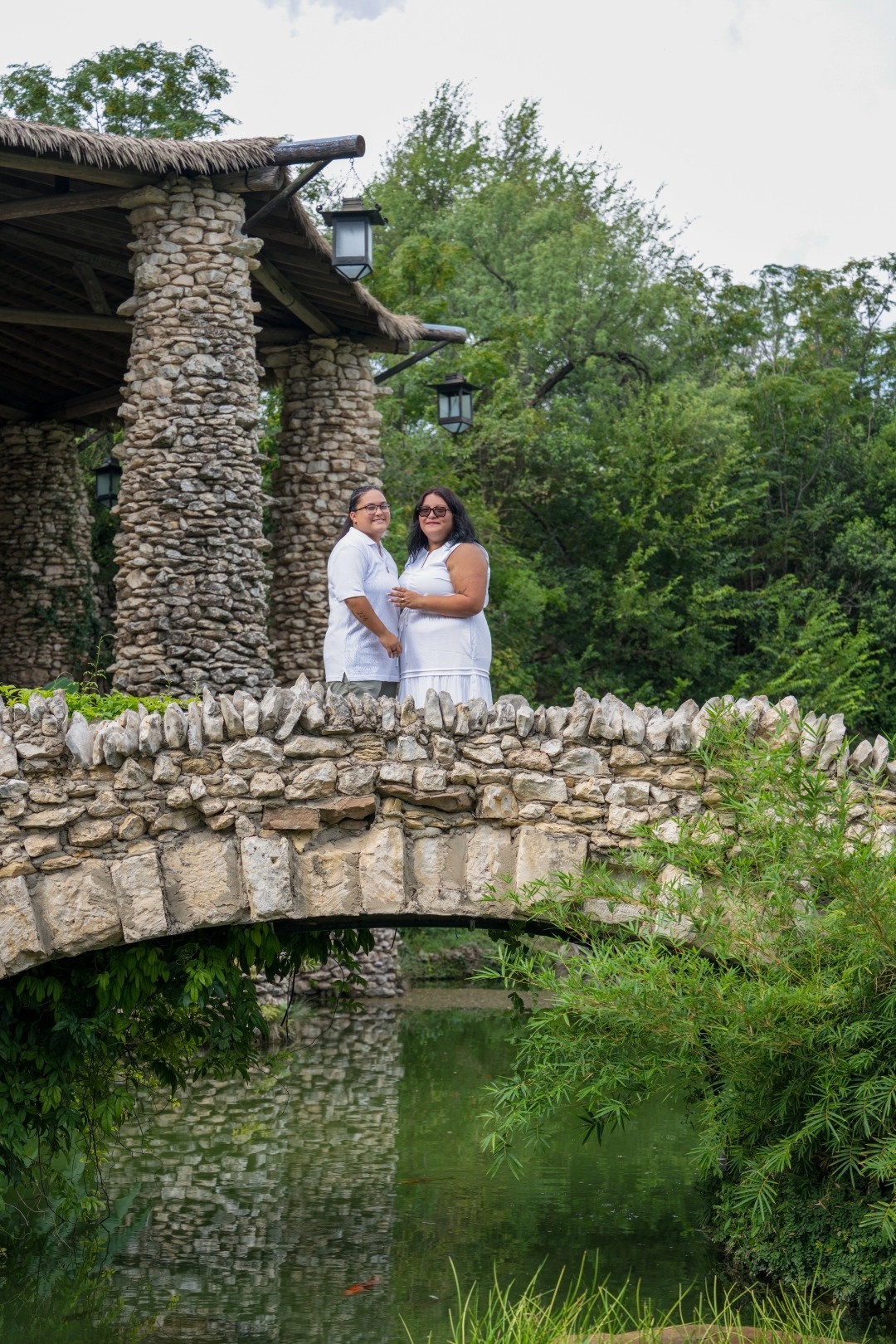 Engaged couple standing on a stone bridge at the Japanese Tea Garden