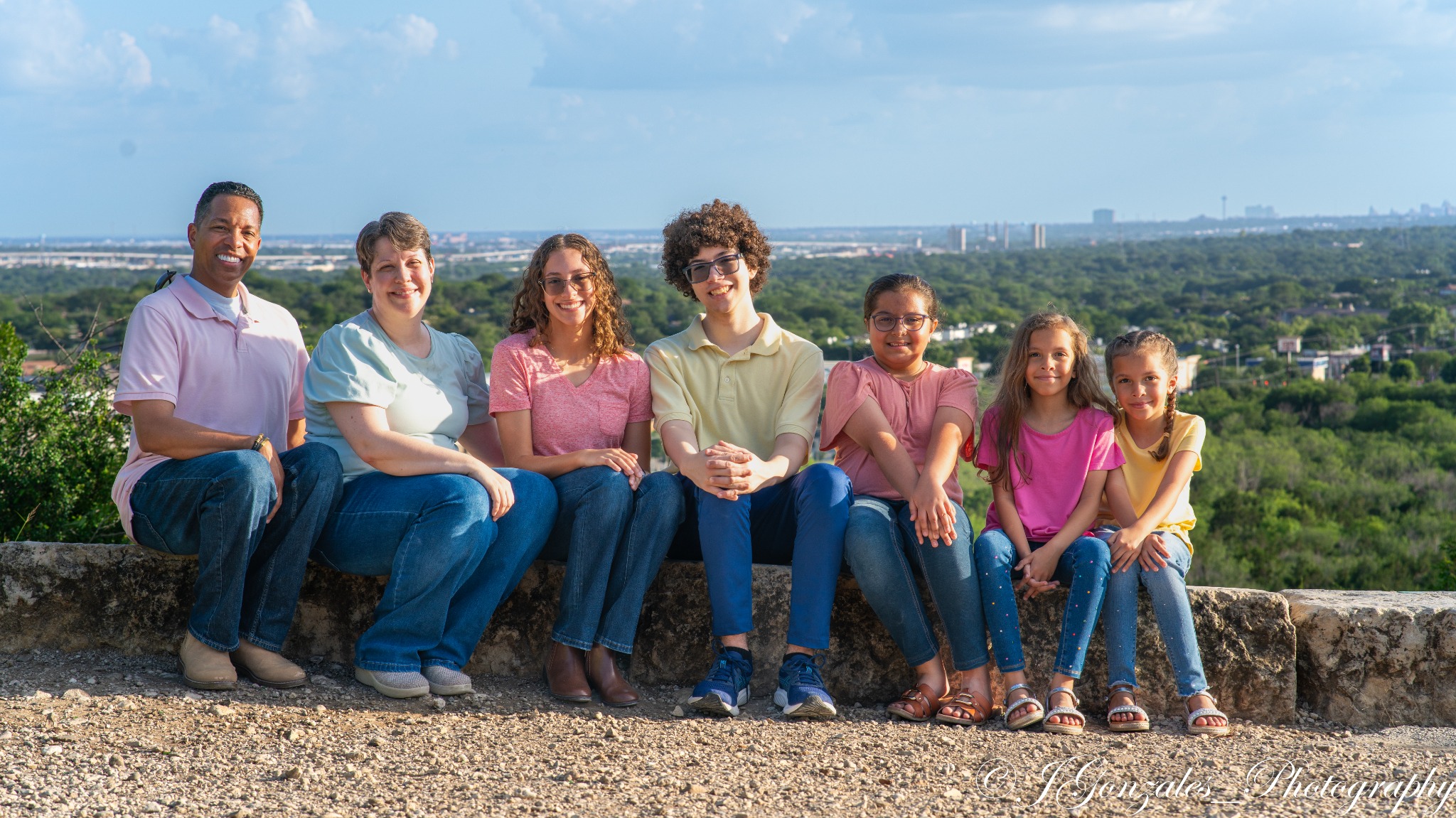 Large family seated together overlooking San Antonio