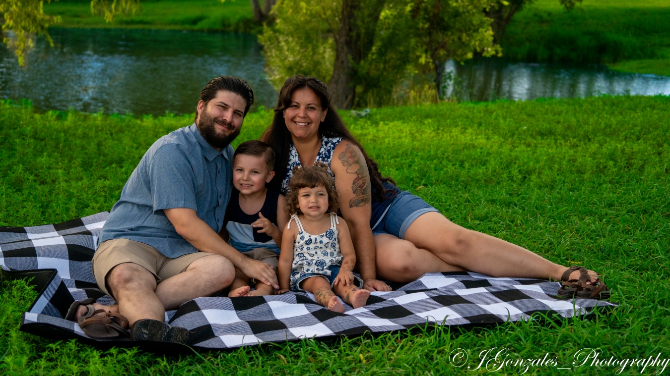 Family sharing time together on a picnic blanket