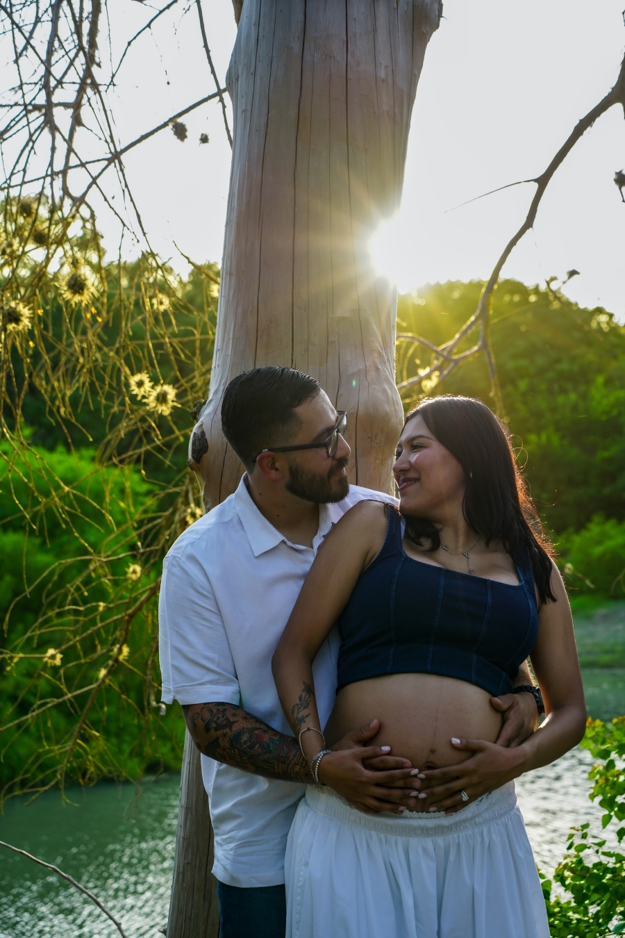 Expecting couple sharing a quiet moment in warm evening light