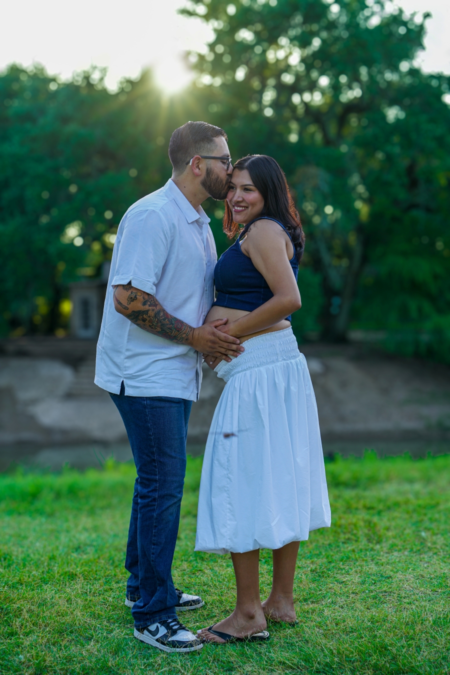 Expecting couple smiling together outdoors