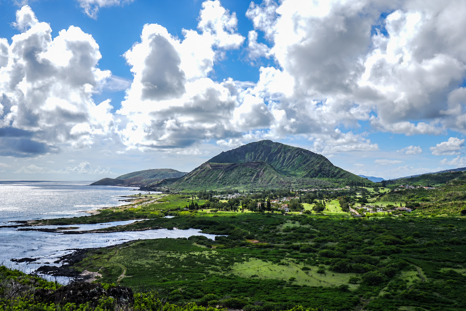 Mountain and coastline beneath dramatic clouds in Hawaii