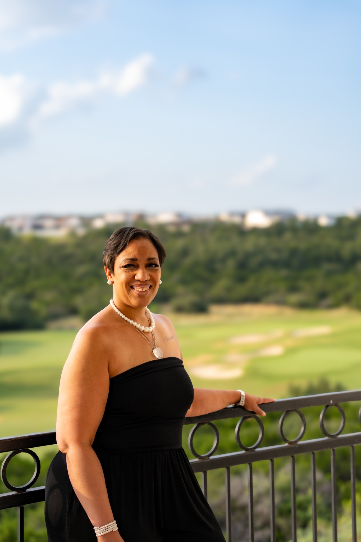 Woman in a black gown overlooking the landscape